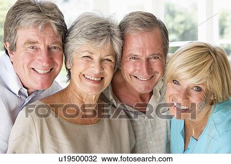 Two couples indoors smiling View Large Photo Image Stock Image - Two couples indoors smiling. Fotosearch
