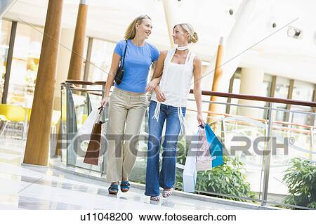 Two women at a shopping mall View Large Photo Image Stock Image - Two women at a shopping mall. Fotosearch