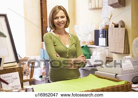 Woman in store smiling View Large Photo Image Stock Photo - Woman in store smiling. Fotosearch