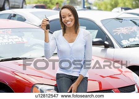 Woman shopping for a new car View Large Photo Image Stock Photo - Woman shopping for a new car. Fotosearch