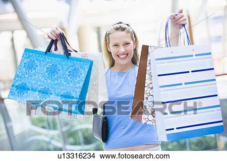 Woman with shopping bags at a shopping mall View Large Photo Image Picture - Woman with shopping bags at a shopping mall. Fotosearch