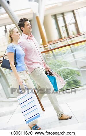 Stock Image - Young couple at a shopping mall. Fotosearch