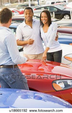 Young couple shopping for a new car View Large Photo Image Stock Image - Young couple shopping for a new car. Fotosearch