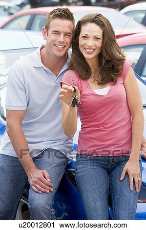 Young couple shopping for a new car View Large Photo Image Stock Image - Young couple shopping for a new car. Fotosearch