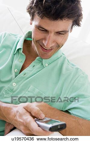 Man indoors text messaging. View Large Photo Image Stock Photograph - Man indoors text messaging.. Fotosearch