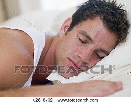 Man lying in bed sleeping View Large Photo Image Stock Image - Man lying in bed sleeping. Fotosearch