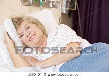 Stock Image - Senior Woman Lying In Hospital Bed. Fotosearch