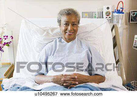 Stock Photo - Senior Woman Sitting In Hospital Bed. Fotosearch