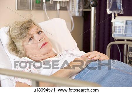 Stock Image - Senior Woman Sleeping In Hospital Bed. Fotosearch