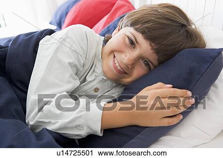 Young Boy Lying Down In His Bed View Large Photo Image Stock Image - Young Boy Lying Down In His Bed. Fotosearch