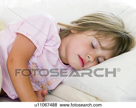 Stock Photo - Young Girl Sleeping In Her Bed. Fotosearch
