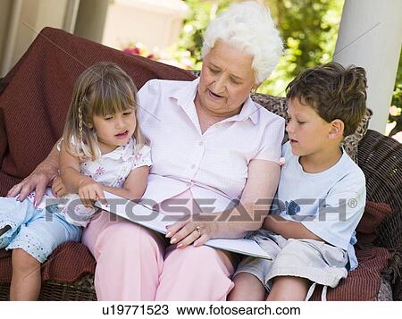 Grandmother reading to grandchildren. View Large Photo Image Stock Image - Grandmother reading to grandchildren.. Fotosearch