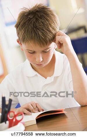Student in class reading book View Large Photo Image Stock Photo - Student in class reading book. Fotosearch