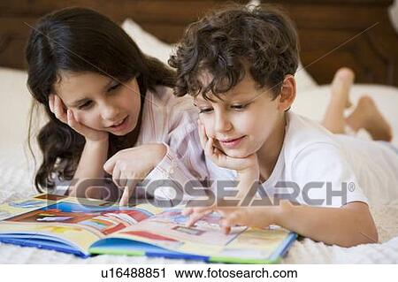 Two young children in bedroom reading book (selective focus) View Large Photo Image Stock Image - Two young children in bedroom reading book (selective focus). Fotosearch