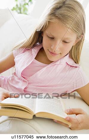 Young Girl Sitting On A Sofa Reading A Book View Large Photo Image Stock Photography - Young Girl Sitting On A Sofa Reading A Book. Fotosearch