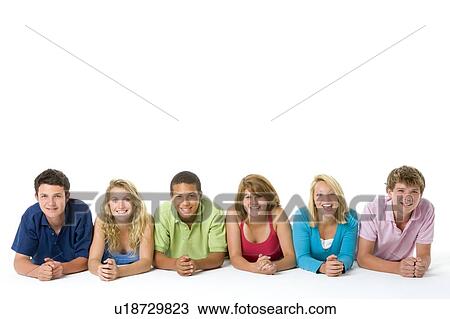 Stock Image - Teenagers Lying Down In A Row. Fotosearch