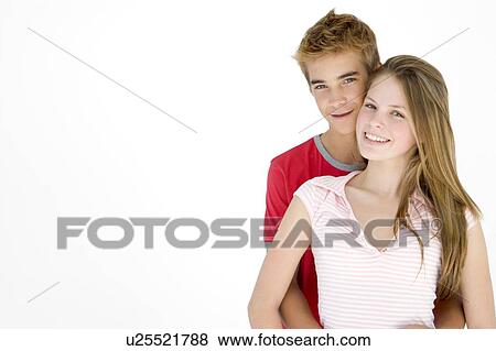 Young couple standing together smiling View Large Photo Image Stock Photo - Young couple standing together smiling. Fotosearch