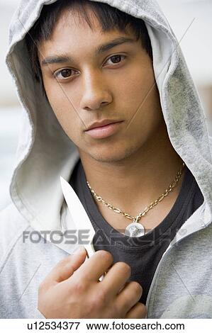 Stock Photo - Teenage Boy Branding Knife. Fotosearch