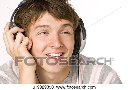 Teenage Boy Listening To Music On Headphones View Large Photo Image Stock Image - Teenage Boy Listening To Music On Headphones. Fotosearch