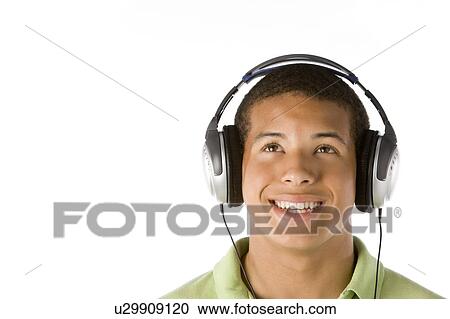 Stock Image - Teenage Boy Listening To Music On Headphones. Fotosearch