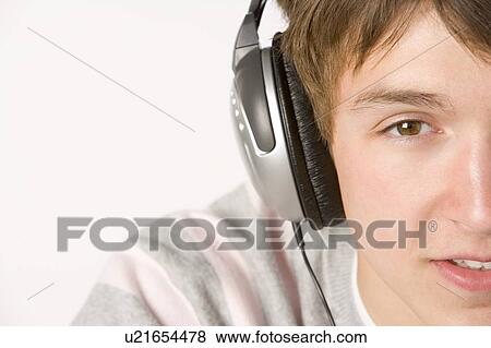 Teenage Boy Listening To Music On Headphones View Large Photo Image Stock Photo - Teenage Boy Listening To Music On Headphones. Fotosearch