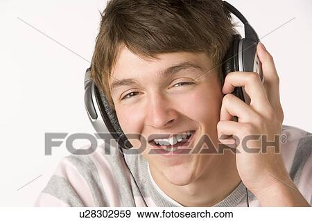 Teenage Boy Listening To Music On Headphones View Large Photo Image Stock Photo - Teenage Boy Listening To Music On Headphones. Fotosearch
