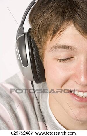 Teenage Boy Listening To Music On Headphones View Large Photo Image Stock Photo - Teenage Boy Listening To Music On Headphones. Fotosearch