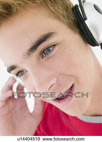 Stock Photo - Teenage boy wearing headphones. Fotosearch