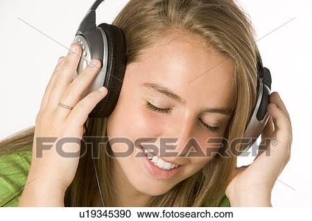 Teenage Girl Listening To Music On Headphones View Large Photo Image Stock Image - Teenage Girl Listening To Music On Headphones. Fotosearch