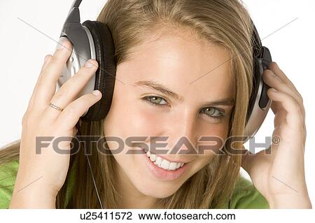 Stock Image - Teenage Girl Listening To Music On Headphones. Fotosearch