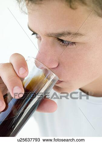 Stock Image - Young boy drinking soda. Fotosearch