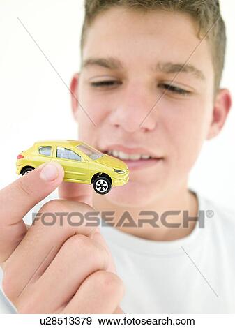 Young boy holding toy car and smiling View Large Photo Image Stock Photo - Young boy holding toy car and smiling. Fotosearch