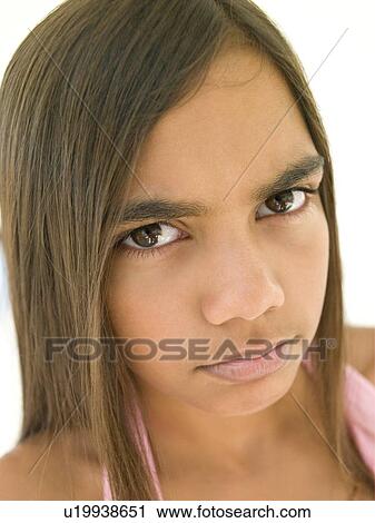 Stock Image - Young girl frowning. Fotosearch