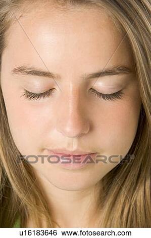 Stock Photograph - Portrait Of Teenage Girl With Eyes Closed. Fotosearch
