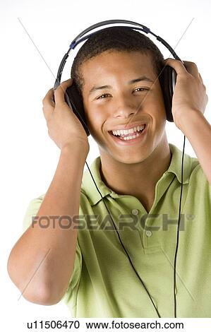 Teenage Boy Listening To Music On Headphones View Large Photo Image Stock Image - Teenage Boy Listening To Music On Headphones. Fotosearch