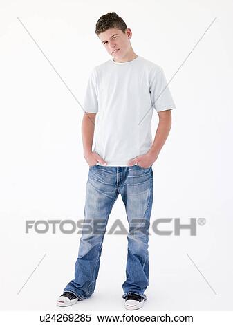 Teenage boy standing with hands in pockets View Large Photo Image Stock Photography - Teenage boy standing with hands in pockets. Fotosearch