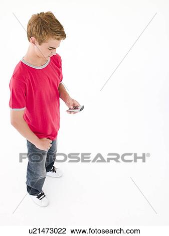 Stock Image - Young boy using cellular phone. Fotosearch