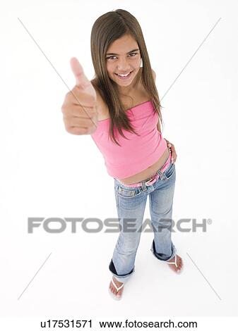 Stock Image - Young girl giving thumbs up smiling. Fotosearch