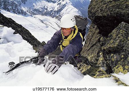 Mountain climber coming up snowy mountain View Large Photo Image Stock Photograph - Mountain climber coming up snowy mountain. Fotosearch