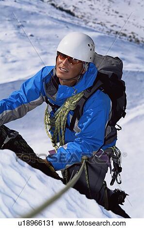 Mountain climber going up snowy mountain (selective focus) View Large Photo Image Stock Image - Mountain climber going up snowy mountain (selective focus). Fotosearch