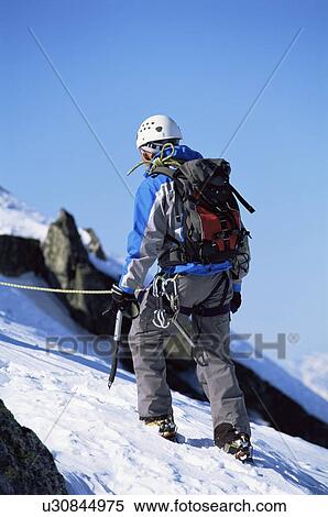 Mountain climber going up snowy mountain (selective focus) View Large Photo Image Stock Photography - Mountain climber going up snowy mountain (selective focus). Fotosearch