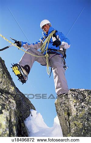 Mountain climber stepping over crevasse on mountain and smiling View Large Photo Image Stock Image - Mountain climber stepping over crevasse on mountain and smiling. Fotosearch