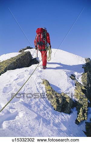 Mountain climber walking on snowy mountain View Large Photo Image Stock Image - Mountain climber walking on snowy mountain. Fotosearch