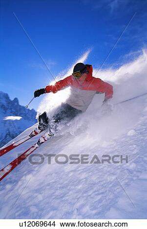Picture - Skier coming down snowy hill (blur). Fotosearch