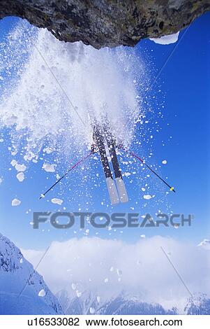 Skier jumping off snowy cliff View Large Photo Image Stock Image - Skier jumping off snowy cliff. Fotosearch