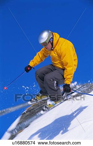 Skier jumping on snowy hill (blur) View Large Photo Image Picture - Skier jumping on snowy hill (blur). Fotosearch