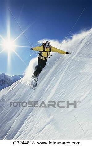 Stock Photo - Snowboarder coming down hill. Fotosearch