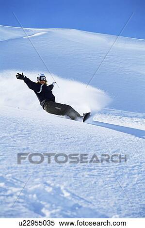Stock Photography - Snowboarder coming down hill. Fotosearch