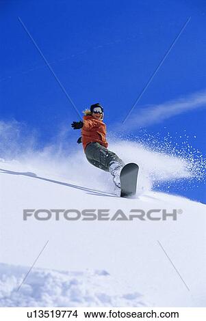 Snowboarder coming down snowy hill smiling View Large Photo Image Picture - Snowboarder coming down snowy hill smiling. Fotosearch