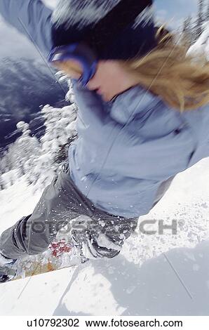 Stock Image - Snowboarder coming down snowy hill (selective focus). Fotosearch